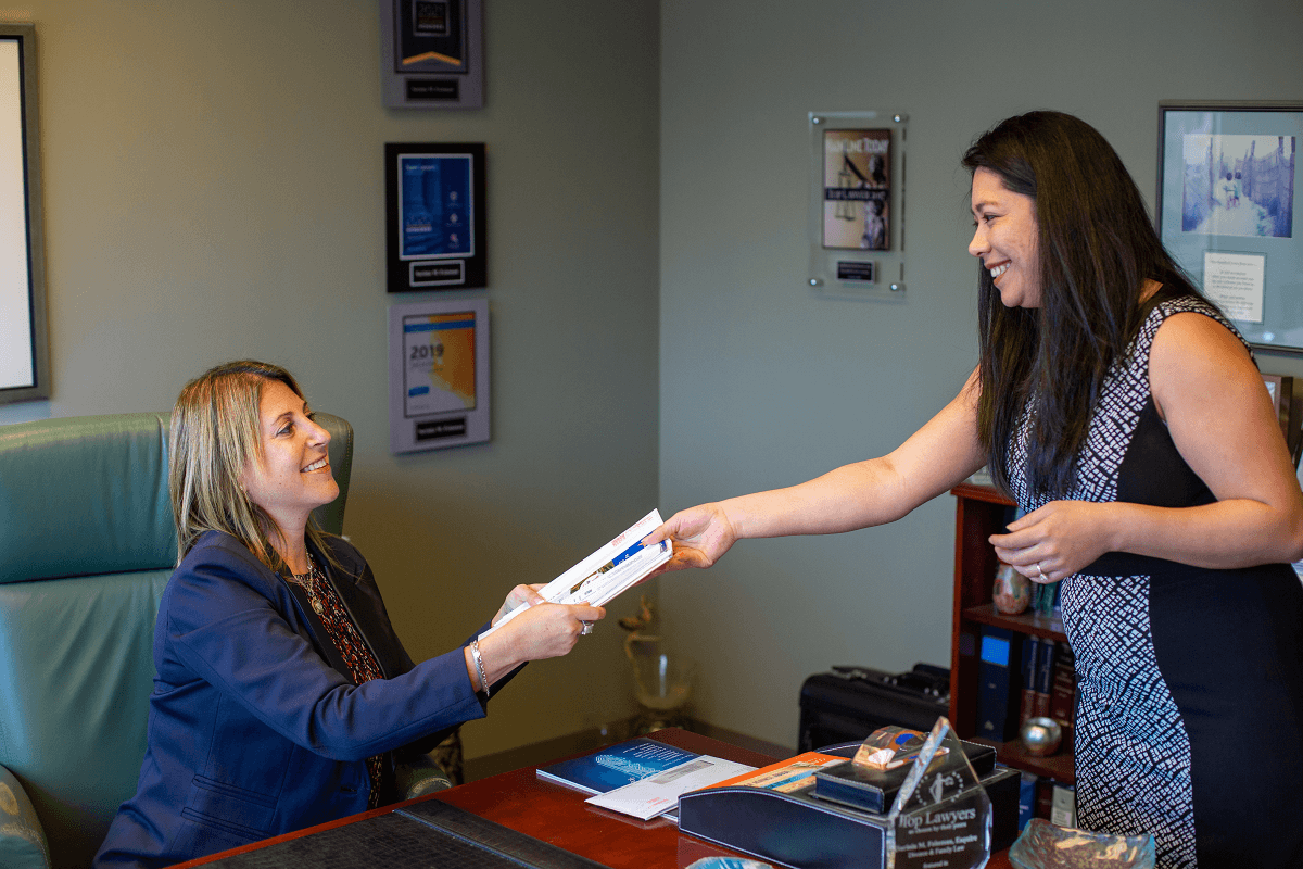 Family Attorney Sarinia Feinman at a desk. Attorneys are still working with clients remotely due to COVID-19 restrictions. | Vetrano | Vetrano & Feinman LLC