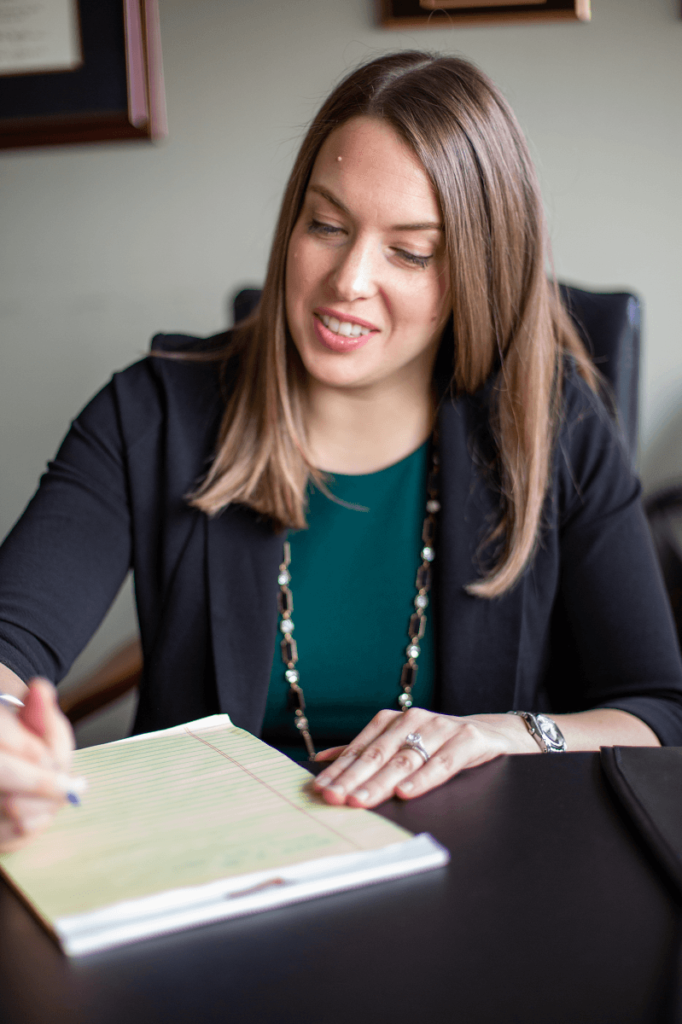 Lindsay Childs at desk with yellow legal pad | Alimony and Cohabitation | Vetrano Vetrano & Feinman